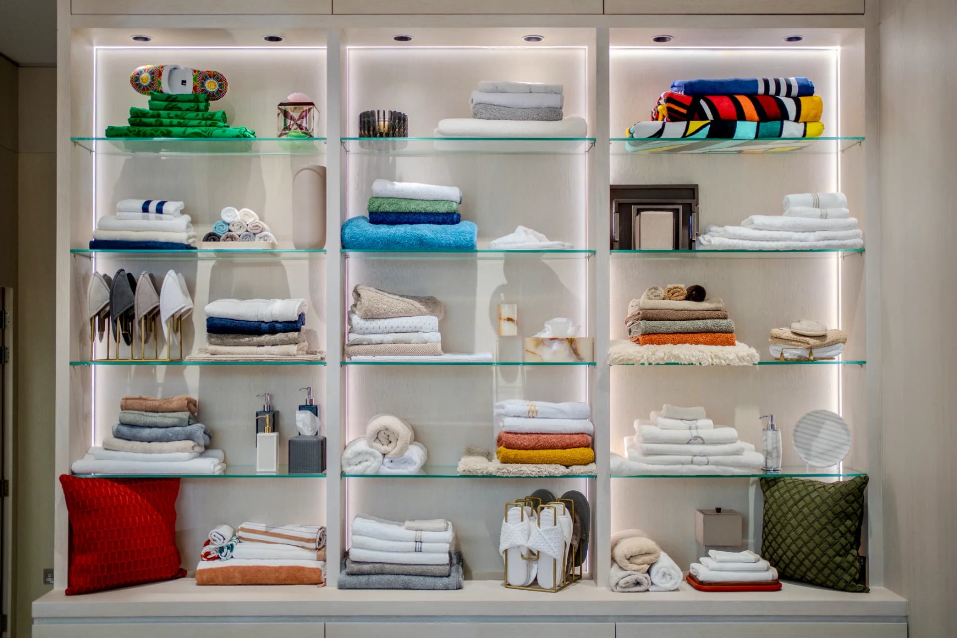 A wall in the glancy fawcett luxury showroom featuring high quality towels and bathroom accessories