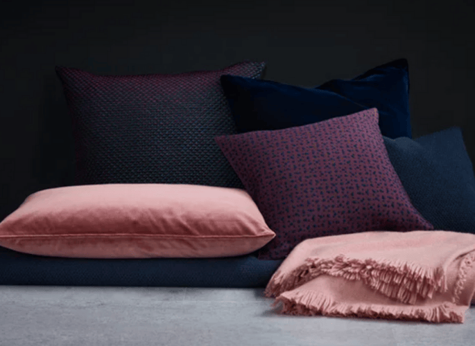 A-mixture-of-different-sized-luxury-cushions-in-pink-blue-and-purple-tones-for-superyachts-homes-and-private-jets