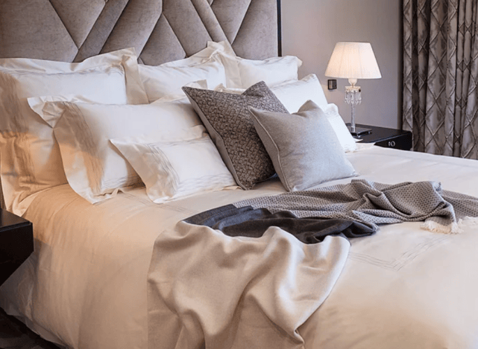 A-close-up-of-a-luxury-bedroom-interior-with-luxury-linens-cushions-and-cashmere-throws