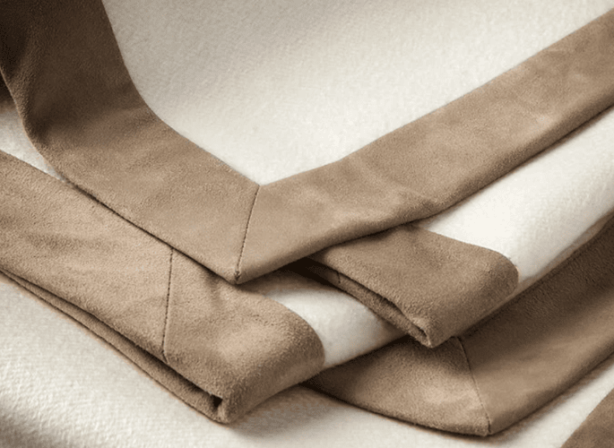 A-cream-coloured-luxury-cashmere-throwwith-a-brown-suede-border-made-for-superyachts-yachts-homes-and-private-jets